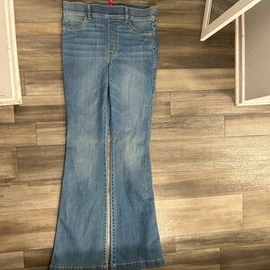 Low rise flare jeans with zipper detail.